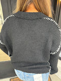 Black collared sweater with white stitching