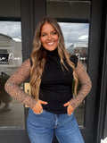 Black mock neck sleeveless sweater